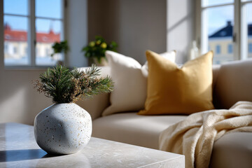 A stylish cozy corner showcasing a soft sofa adorned with textured pillows, featuring an artistic vase with greenery, creating an inviting atmosphere for relaxation.