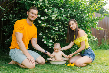 Happy Family with Baby Playing Outdoors