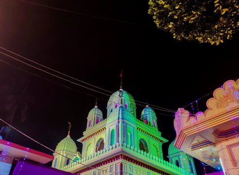 Indian Hindu temple with ancient architectural details under a night sky.
