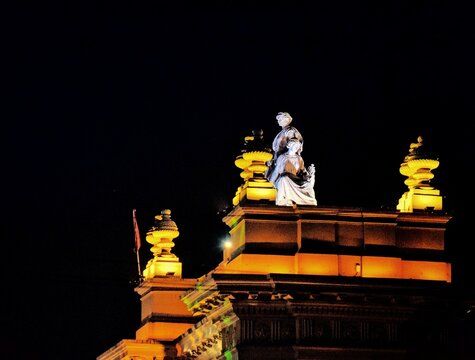 Indian Hindu temple with ancient architectural details under a night sky.