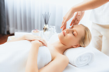 Caucasian woman enjoying relaxing anti-stress head massage and pampering facial beauty skin...