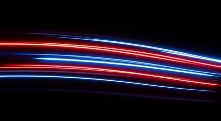 Vibrant red and blue light trails moving swiftly across a dark background