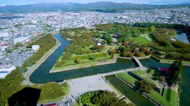 High angle view of Hakodate city from Goryokaku Tower. It shows the star shaped fort and the Tsugaru Strait during autumn in Hokkaido Japan.