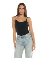 Obraz premium Studio shot of a young woman wearing black tank top and jeans, natural beauty portrait on white background