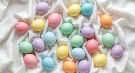 Pastel Easter eggs scattered on soft white draped fabric, minimalist spring holiday background for greeting cards.