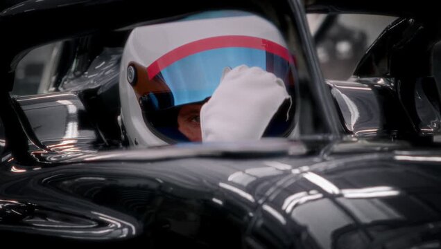 A fast racing car stands in the pitlane garage before the race