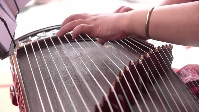 Chinese traditional musician playing Chinese guzheng