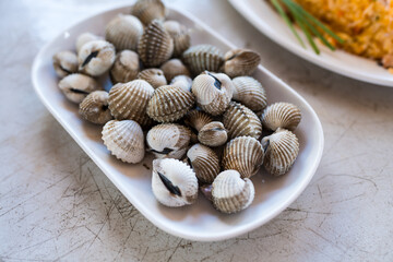 Shellfish Boiled cockle ocean gourmet seafood in the restaurant, Cockles on a plate.