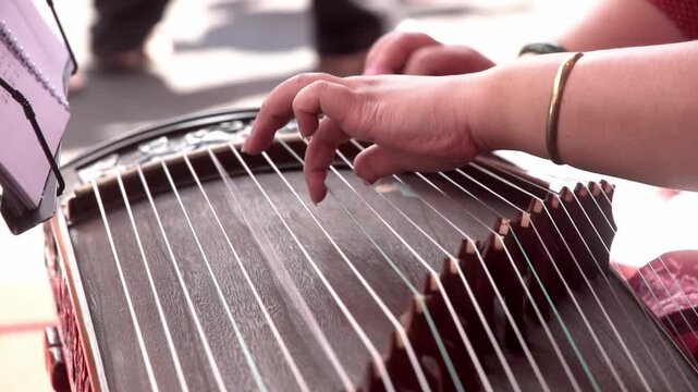 Chinese traditional musician playing Chinese guzheng