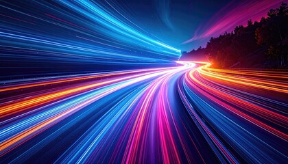 Abstract long-exposure capturing light trails across a road curving through landscape