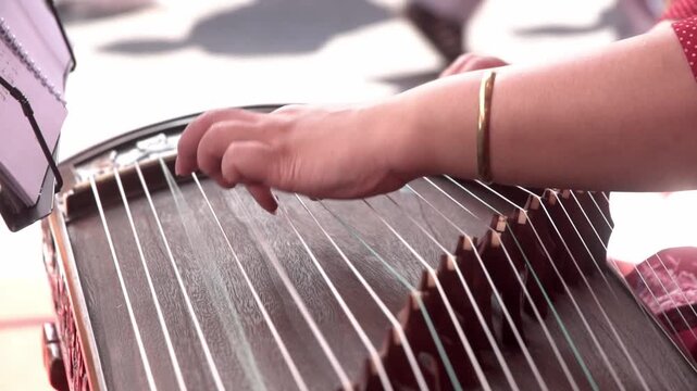Chinese traditional musician playing Chinese guzheng