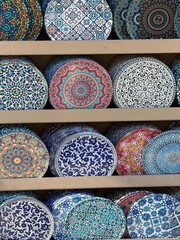 Colorful decorative plates in ornate patterns displayed as artistic background or cultural concept