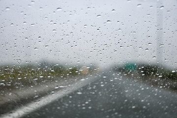 raindrops on windscreen while driving on a rainy day