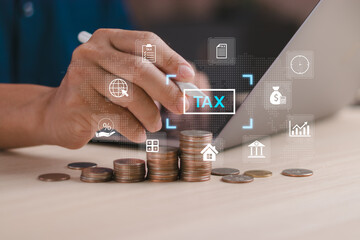 concept of finance or income in online tax calculation, man uses a stylus to touch virtual computer screen to manage income or expenses or fill out personal or corporate income tax form.