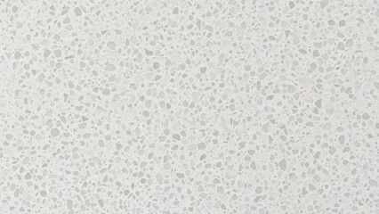 A white, textured surface with irregular, speckled patterns.