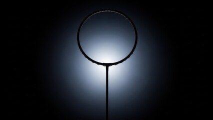 Silhouette of a Badminton Racket Against a Dark Background