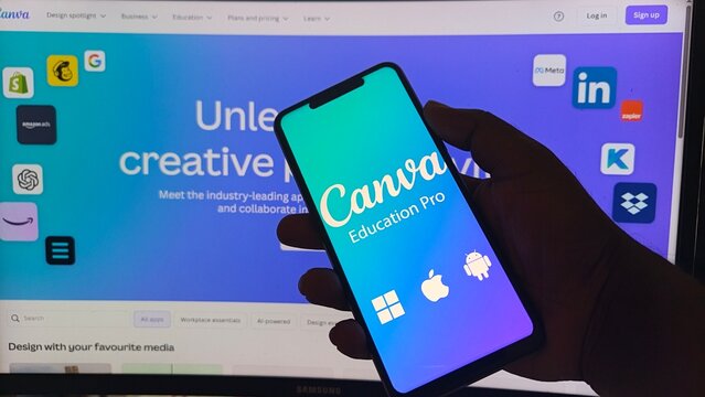 Hand holding smartphone with Canva Education Pro on screen