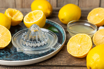 Lemon juice. Fresh lemon juice in a bowl. Ripe citrus, mint, fruit, and a juicer on the table. Vitamin C. Lemon water. Ingredient for baking or salad dressing. Space for text. Copy space.