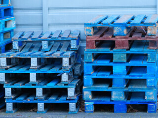 blue painted wooden pallets stacked on top of each other