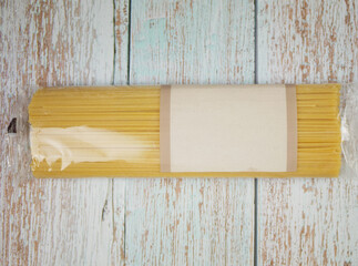 Packaged spaghetti bundle placed on distressed wooden surface showing pasta shape, clean product layout, and ingredient clarity for culinary themes, branding visuals, and modern food design, pro photo