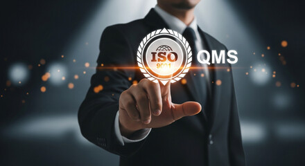 A corporate professional touches a luminous ISO Quality Management System icon, highlighting global standards.