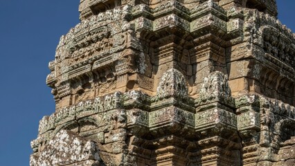 A close-up view of an ancient stone temple with intricate carvings and ornate details.
