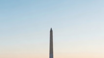 The Washington Monument stands tall against a serene blue and pink sky at sunset