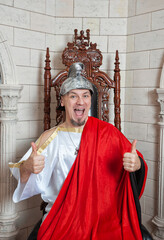 Confident funny smiling man wearing medieval costume showing thumbs up