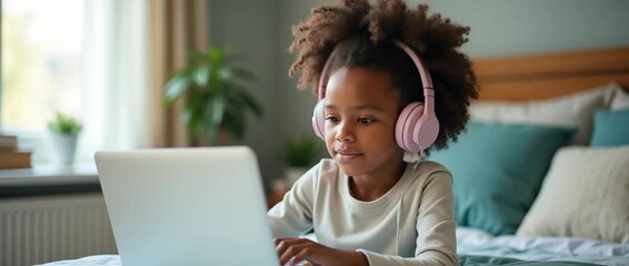 Young girl with headphones engaged in online learning on a laptop in a cozy bedroom; camera gently pans across the scene while soft morning light casts a warm, inviting glow, cinematic style. - Powered by Adobe