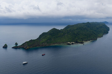 Rain clouds drift towards the remote island of Warakaraket in Misool, Indonesia. This region harbors spectacular marine biological diversity and is a popular destination for divers and snorkelers.