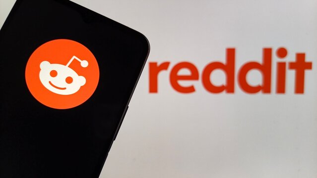 Reddit logo on smartphone screen with blurred background