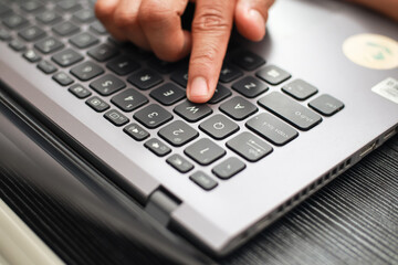 Close Up Of A Finger Pressing A Laptop Keyboard Button With Shallow Depth Of Field
