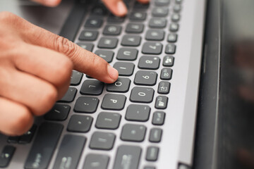 Close Up Of Person Typing On A Laptop Keyboard In A Well Lit Room