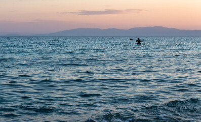 A man is in a kayak in the sea