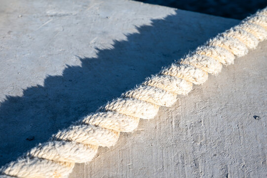 Weathered ship rope lying at the quay of Birżebbuġa, highlighting texture, maritime character and the passage of time along the Mediterranean coast Birżebbuġa, Malta, 6 DEC 2025
