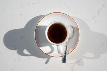 Coffee served in a white cup with a pink rim, styled on a table in Sliema, highlighting a cozy Mediterranean caf&eacute; moment Sliema, Malta, 9 DEC 2025.