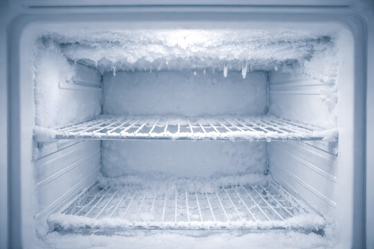 Empty Freezer Interior with Ice Crystals and Frost