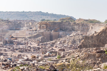 industrial stone mining area with exposed granite formations in Aravalli range