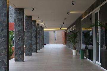 Modern building corridor with stone columns and minimalist design