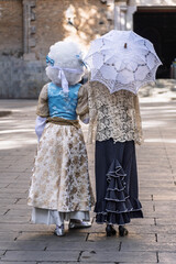 Women in Modernist Period Costumes with Lace Umbrella