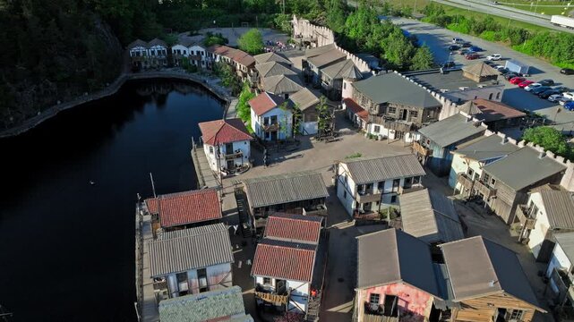 he fortified walls, wooden pirate houses, canals, lighthouse, and surrounding forested landscape are all characteristic features of Abra Havn, a themed harbor area along the Topdalsfjorden.