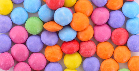 Colorful round dragee candies macro background