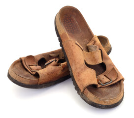 Old worn leather sandals isolated on white