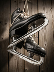Skates hanging on a rustic wooden wall