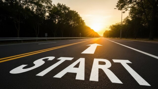 A road with the word start painted on it at sunrise or sunset