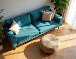 Modern boho living room features teal sofa with neutral pillows. Round jute pouf rests on light wood herringbone floor. Bright sunlight streams through sheer curtains, casting shadows.