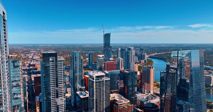 Rising over the tops of the beautiful high-rises in the vibrant metropolis. Revealing view on the Colorado River in Houston, Texas, USA.