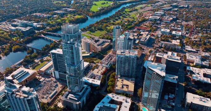Footage over the picturesque waterfront of the Colorado River with lively traffic on bridges. Sunny cityscape of Houston, Texas, USA.