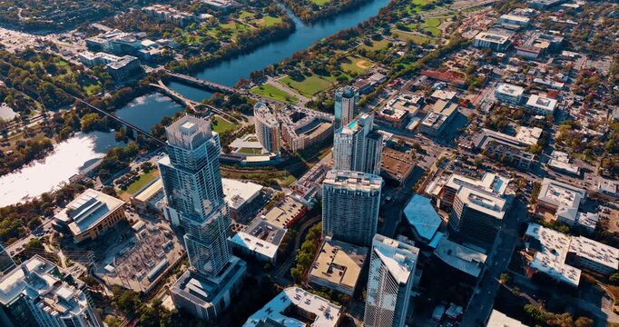 Approaching the beautiful green park at the waterfront of the Colorado River. Bright sun dazzles the cityscape of a beautiful city.