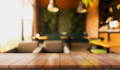 Empty wooden table top with lights bokeh on blur restaurant background.